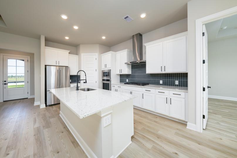 Enjoy a fully loaded kitchen with a modern tile backsplash.