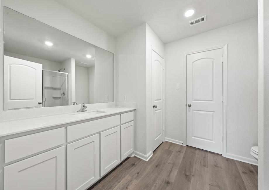 The master bathroom has a large vanity with plenty of counterspace.