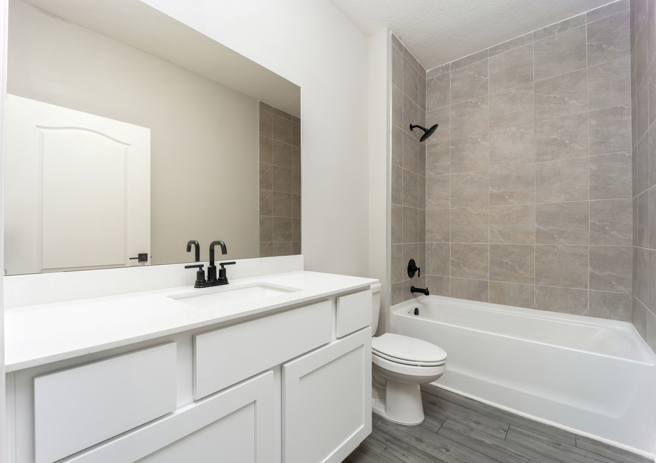 The spare bathroom has a spacious vanity ready for your guests to use