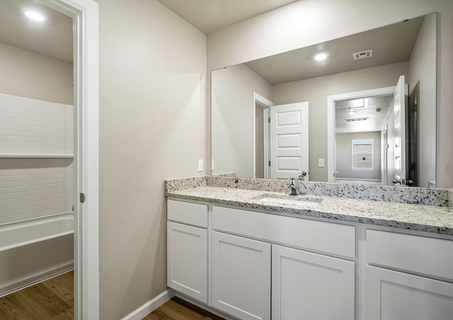 The guest bathroom has tons of counter space for guests or family to get ready.