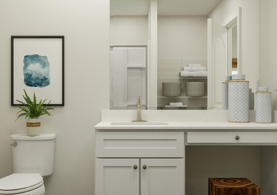 Rendering of the spacious master bath
  focused on the sink, which has white cabinets and a makeup vanity. The toilet
  is beside it and in the mirror's reflection the shower and linen storage is
  visible.