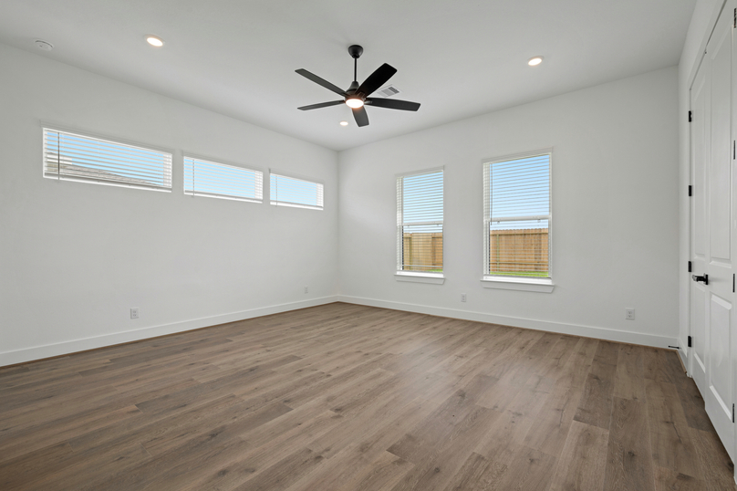 Primary bedroom with large windows.