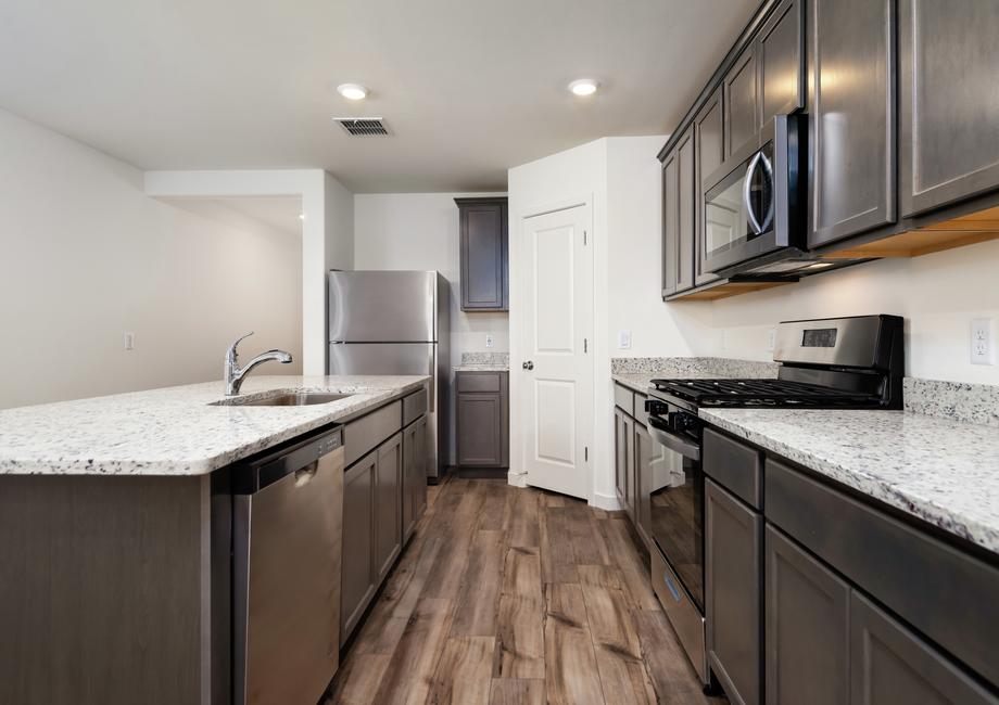 The kitchen has wood cabinets and granite countertops