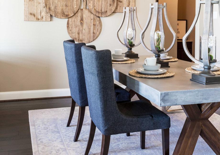 Dining room with dining room table, chairs, and rug.