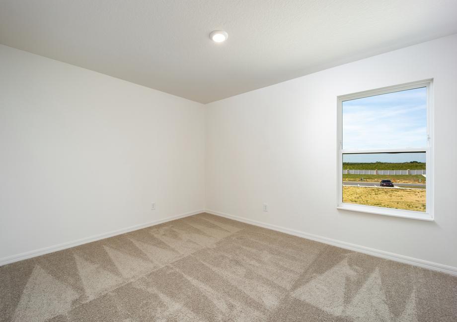 A bedroom with a window that provides natural light