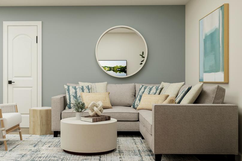 Rendering of the second-story game room
  in the Sequoia plan. The room is furnished with a sectional couch, accent
  chair, coffee table and side table.