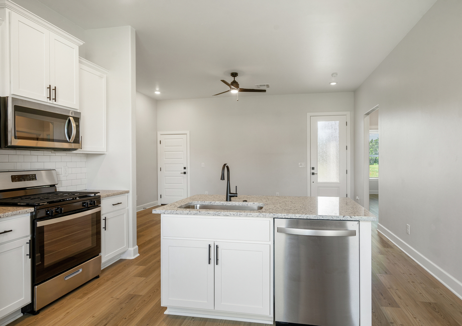 The gorgeous kitchen looks over into the family room.