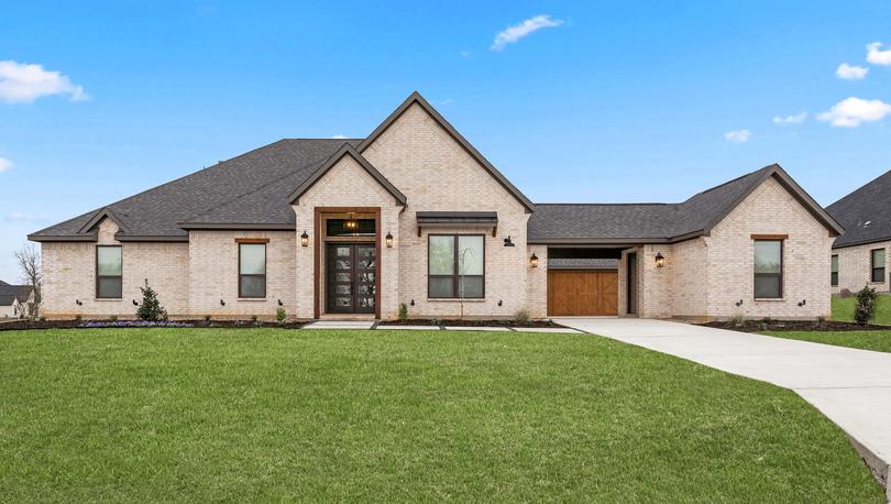 The Garza is a beautiful, one-story brick home with wood accents.