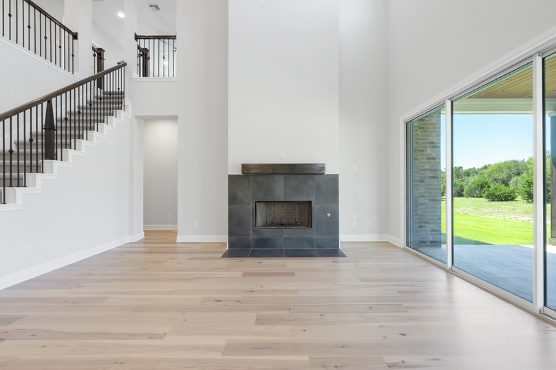 The spacious living room has plenty of space for large furniture.