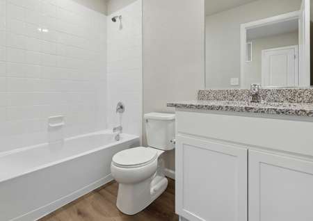The secondary bathroom includes a shower-bathtub comination and a wonderful granite countertop vanity.