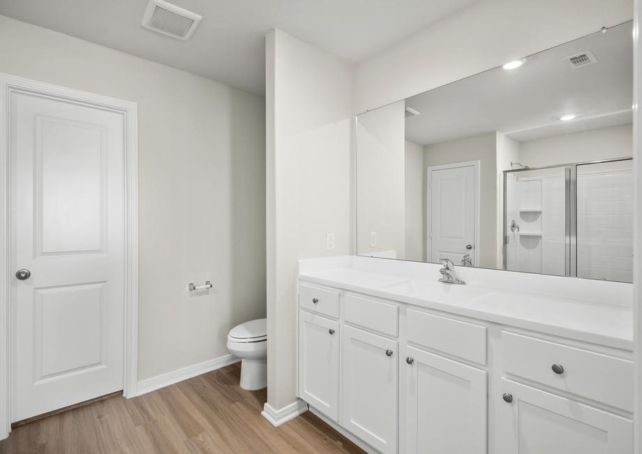 The master bathroom has a long vanity with plenty of storage space.