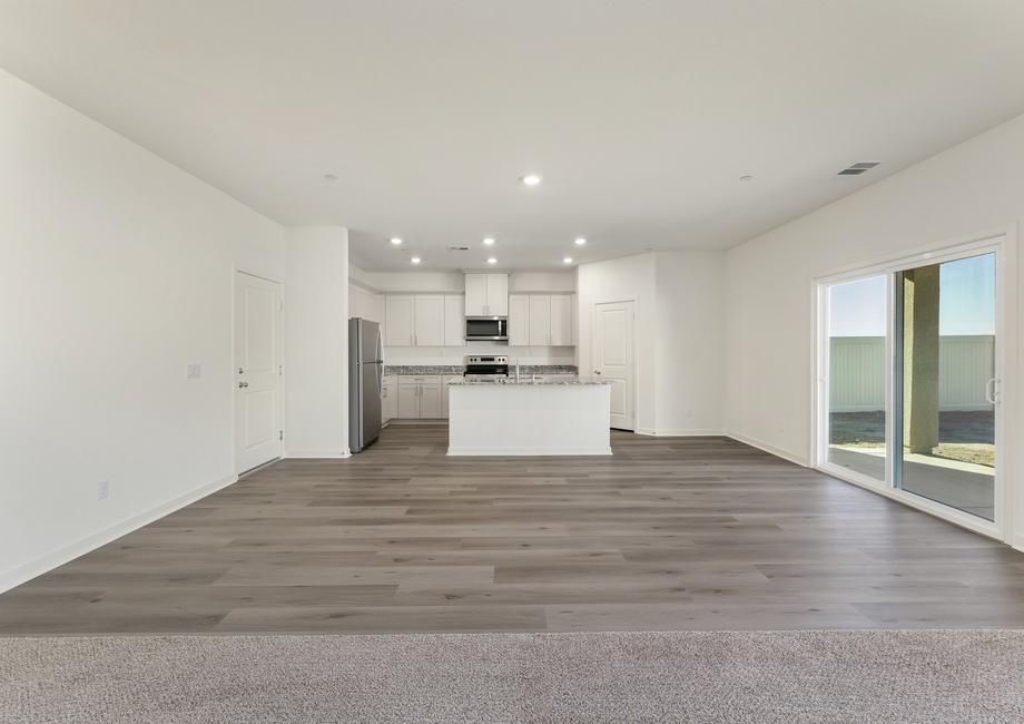 The chef ready kitchen has plank flooring and stainless steel appliances.