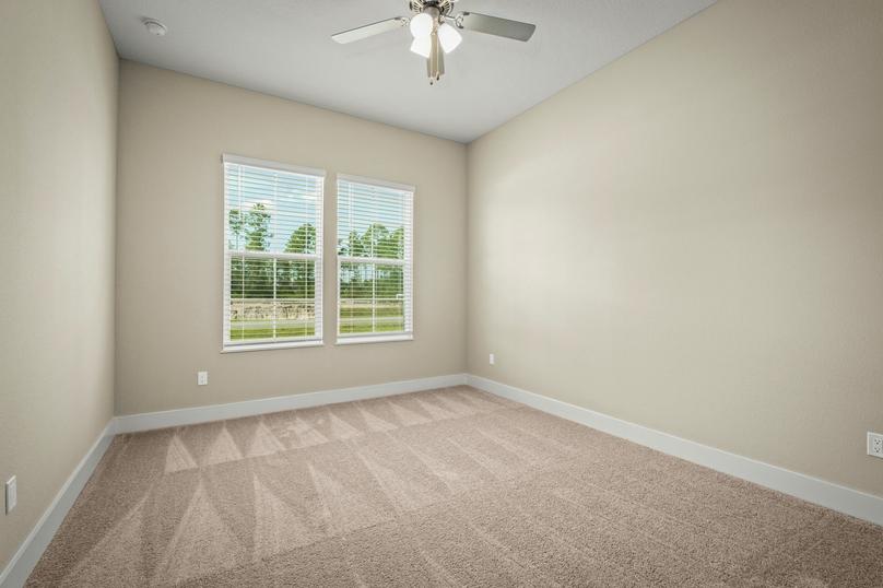 Secondary bedroom with carpet.