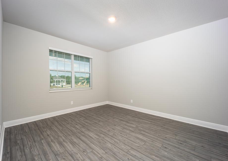 A formal dining room with a large front window