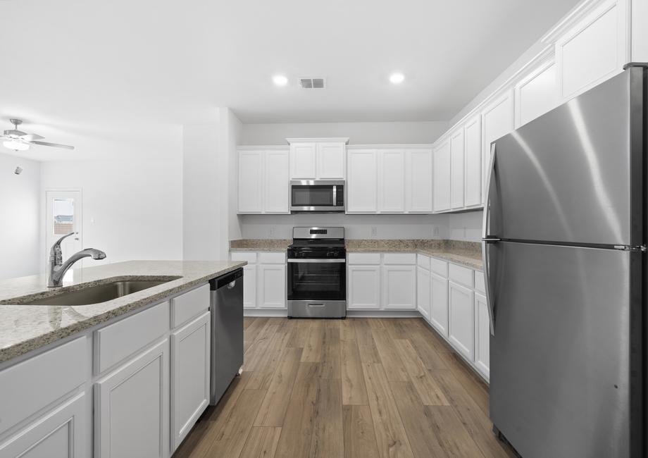Upgraded kitchen with granite countertops and stainless appliances.