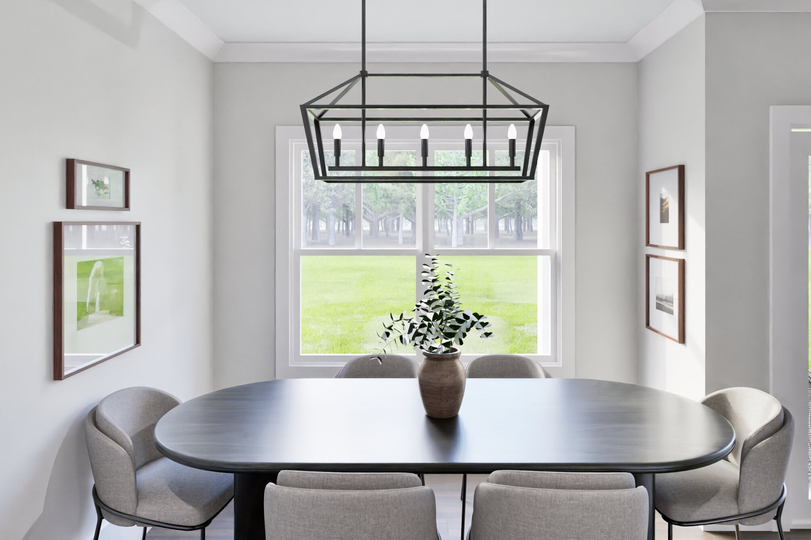 A dining room featuring a wooden table surrounded by four chairs, with warm lighting and decorative elements.