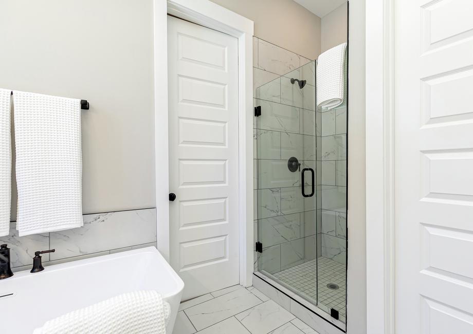 Master bathroom with standalone tub and walk-in shower.