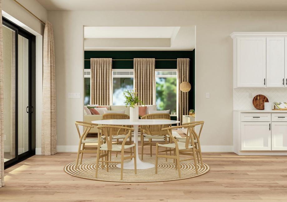 Rendering of the breakfast nook furnished
  with round table and leather chairs next to large sliding glass door. The
  nook opens into the large sitting area and kitchen where herringbone tile
  backsplash can be seen.