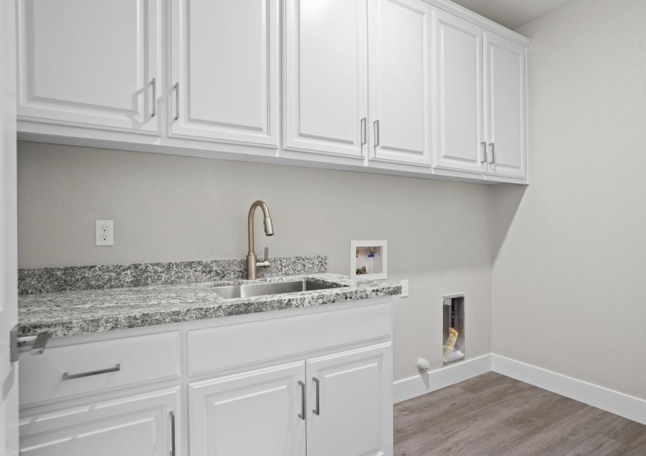 Fully loaded laundry room with a sink