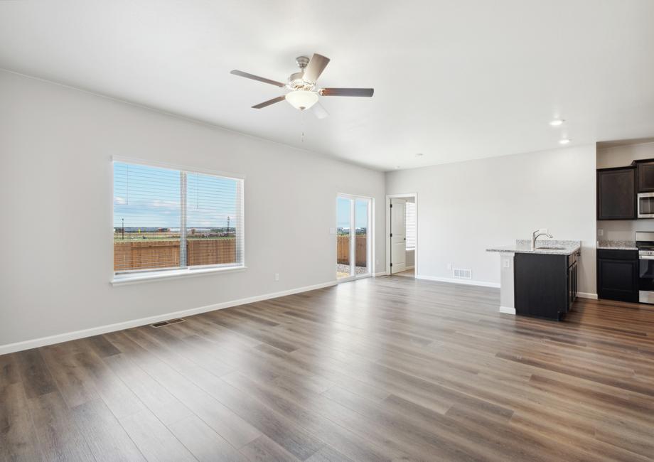 Open layout with a large family room, dining area, and upgraded kitchen.