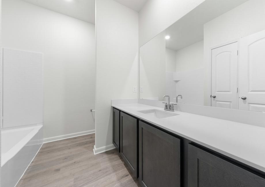 The secondary bathroom of the Reed has a large vanity space and shower-tub combo.