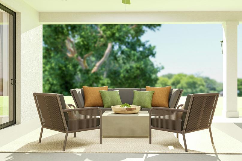 Rendering of the covered patio featuring
  an outdoor sofa, two armchairs, coffee table and rug looking out to the
  backyard.