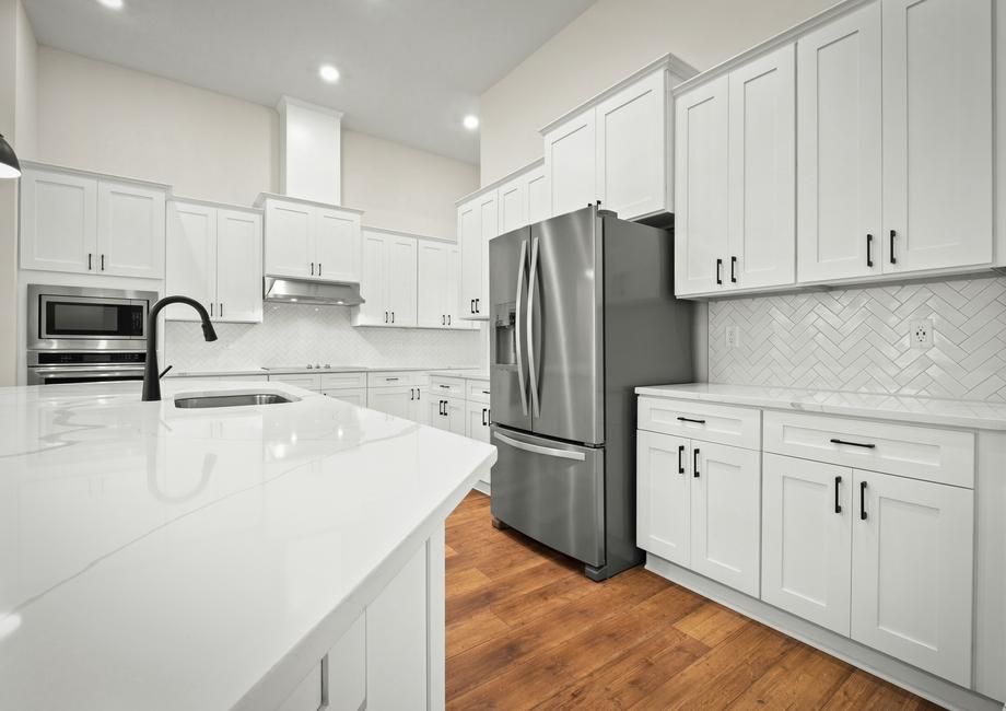 The kitchen includes stainless steel appliances.