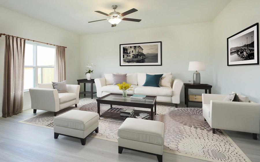 Living room with a couch, two chairs and coffee table.