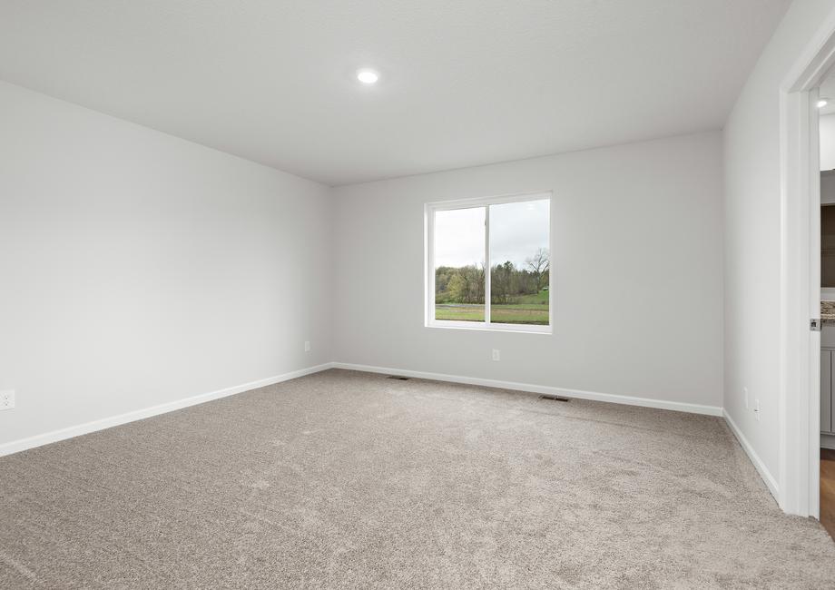 The master bedroom is spacious and has a large window.