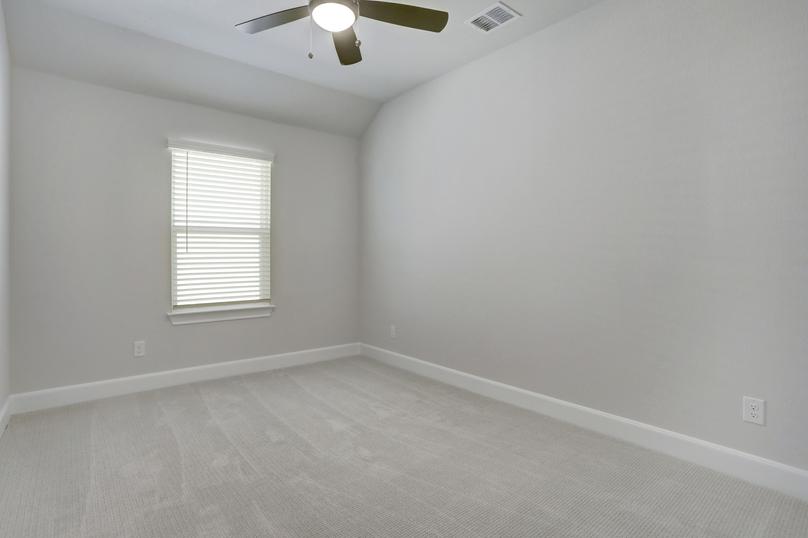 Guest bedroom with carpet and a ceiling fan.