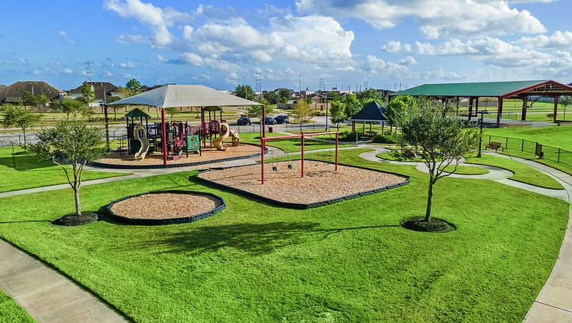 Playground with swings, play structure and a covered basketball court.