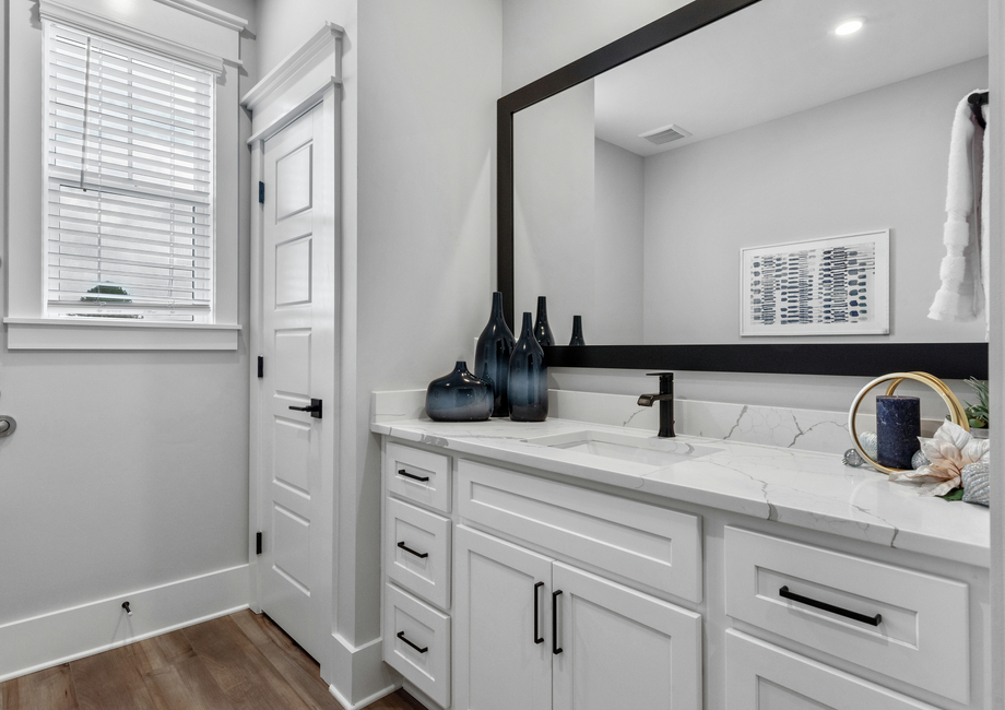 The secondary bathroom has a large vanity.