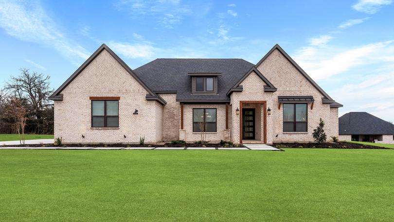 The Bradley II is a beautiful, one-story brick home with wood accents.