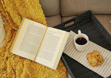 Open book, coffee mug, and cookies