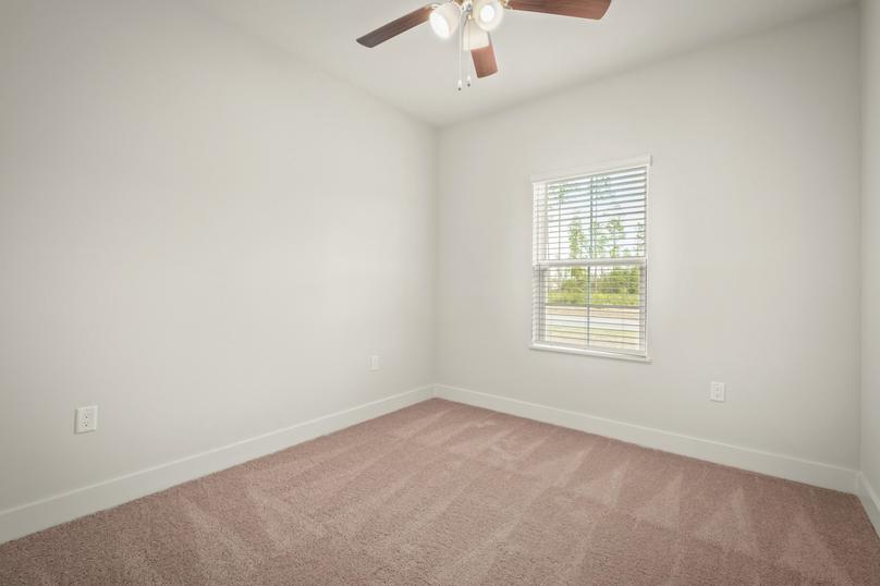 The secondary bedrooms are large and include ceiling fans.