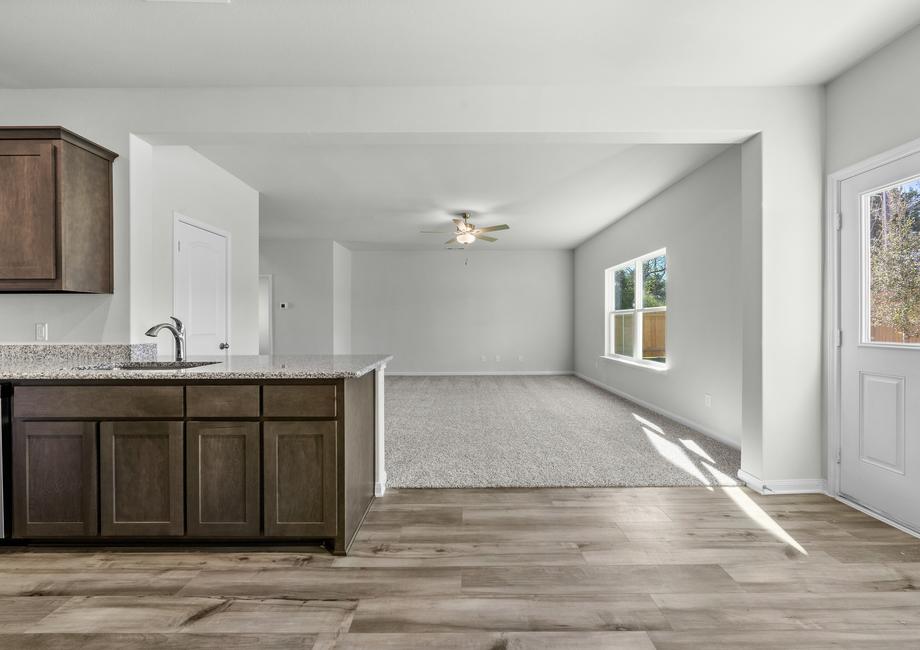 The family room of the Cypress floor plan sits adjacent to both the kitchen and dining room.