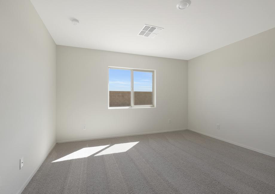 Master bedroom with large windows that allow natural light in.