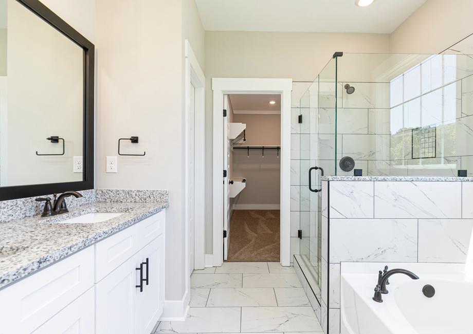 Master bathroom with large vanity and a walk-in shower.