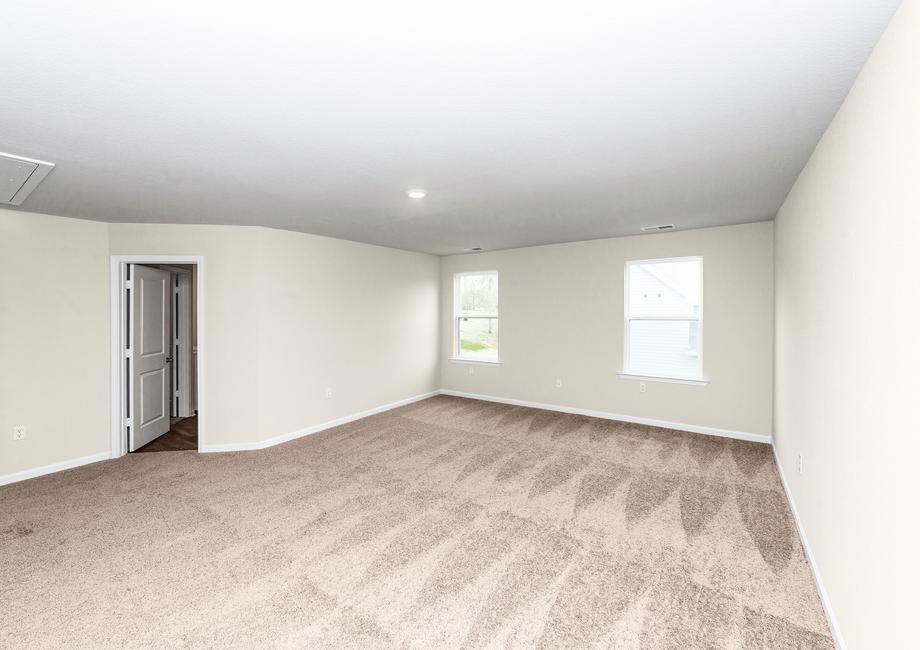 The master bedroom is spacious and has direct access to a bathroom with two walk in closets