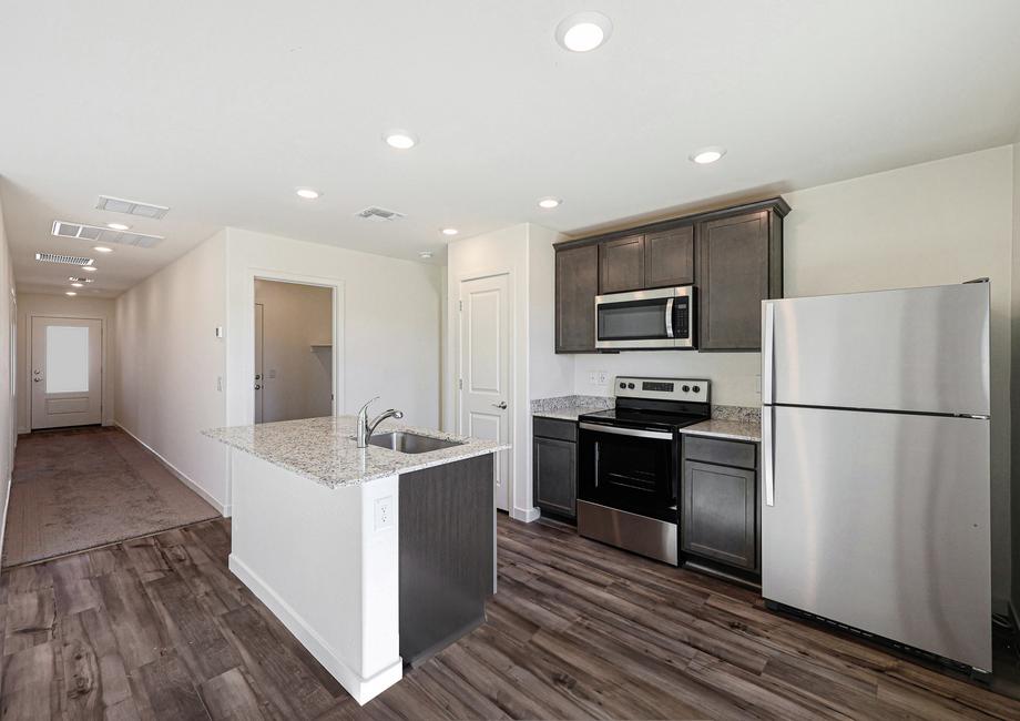 Enjoy stunning granite countertops and designer wood cabinetry in this kitchen.