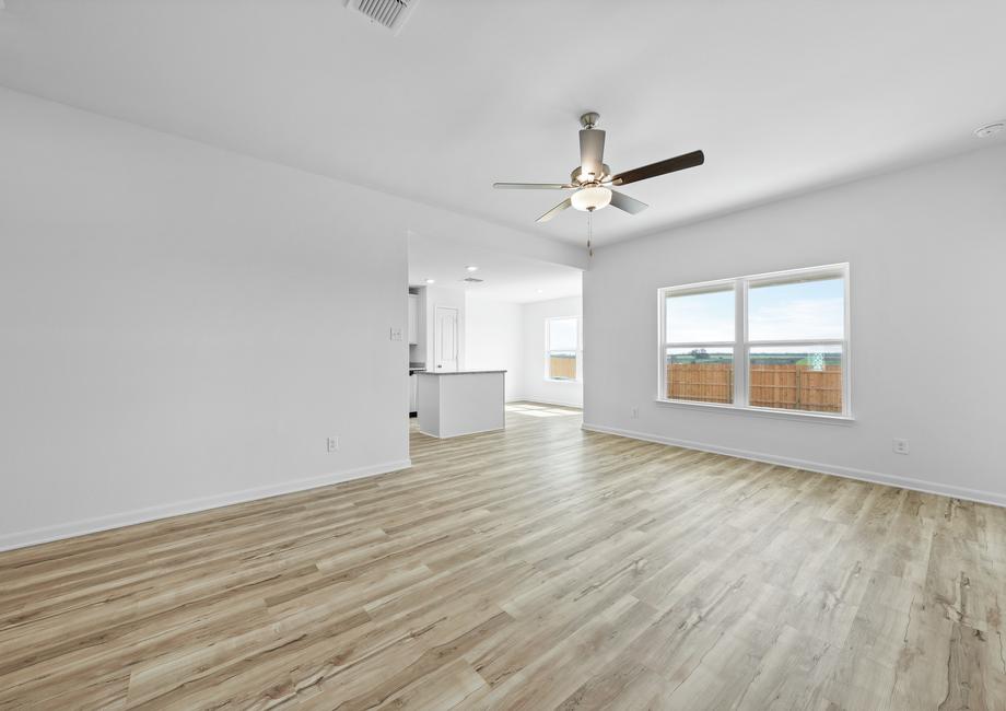 The spacious family room with light wood luxury vinyl flooring