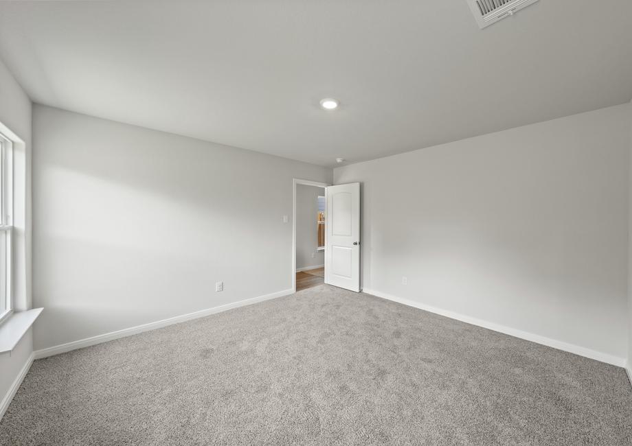 The spacious master bedroom of the Cedar has a large window that lets in great, natural light.