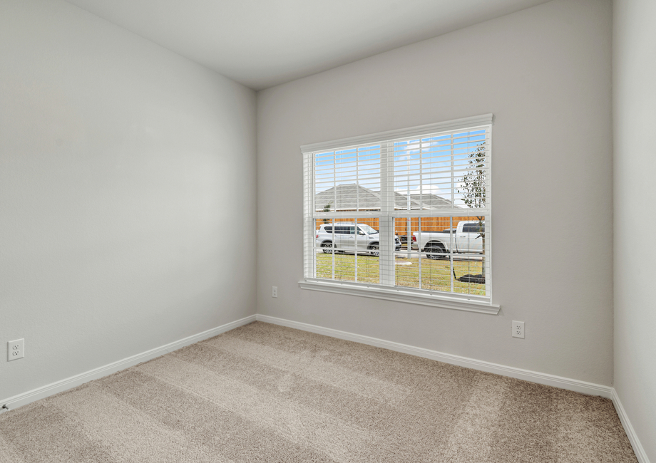 The second bedroom features a large window