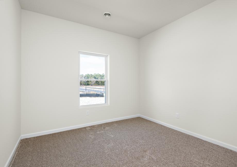 The secondary bedroom has carpet and window.