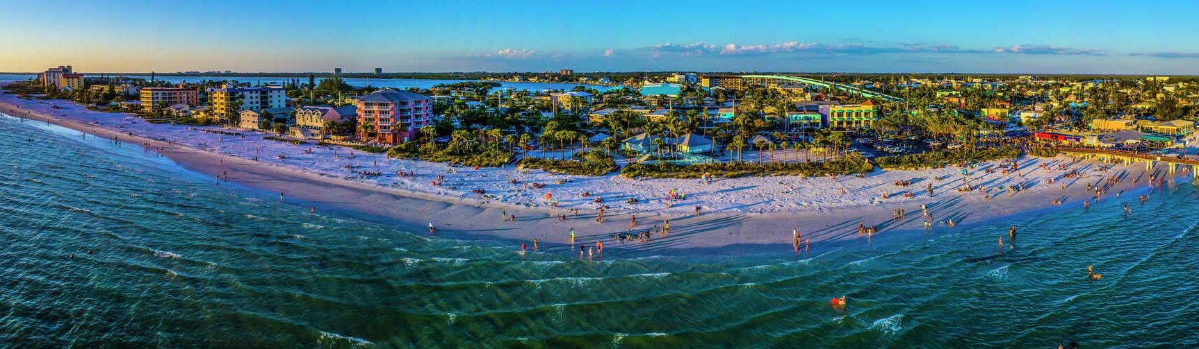 Fort Myers beach in Florida panoramic view showing entire beach, properties, and sky on the horizon