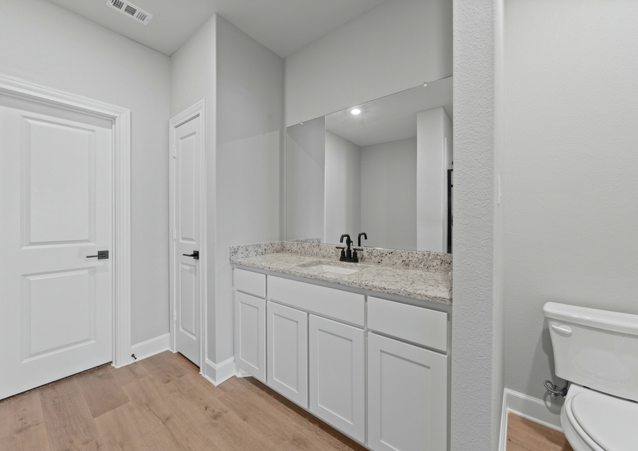 The master bathroom has a large vanity space.