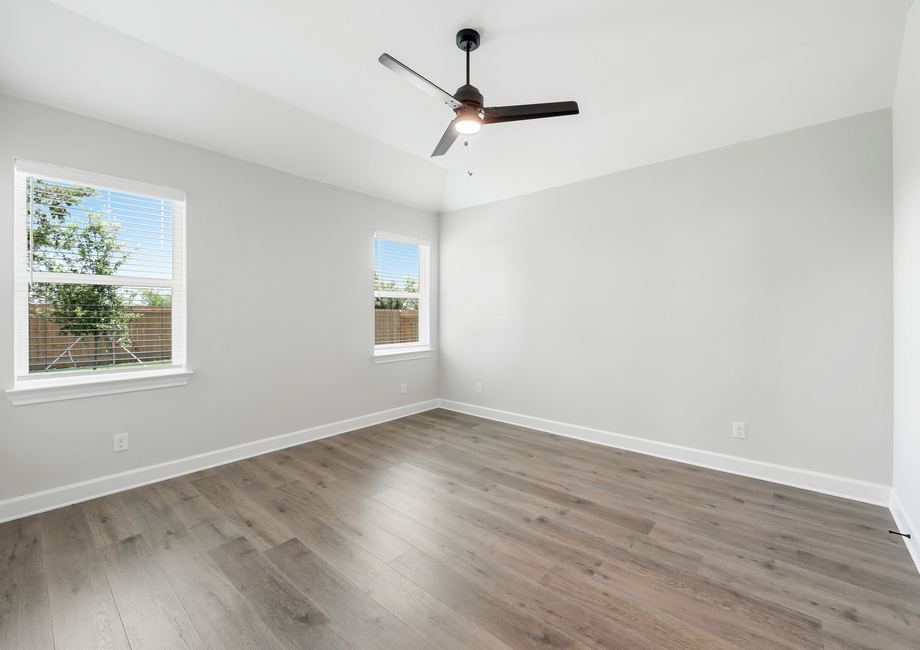 The spacious master bedroom has two large windows that let in great, natural light and backyard views.