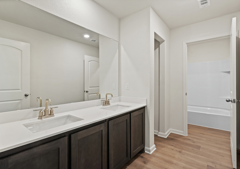 The secondary bathroom has a dual sink vanity.