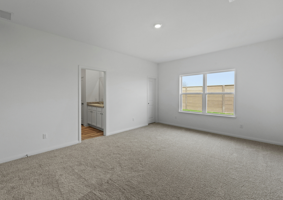 A large window in the master bedroom brings in natural light