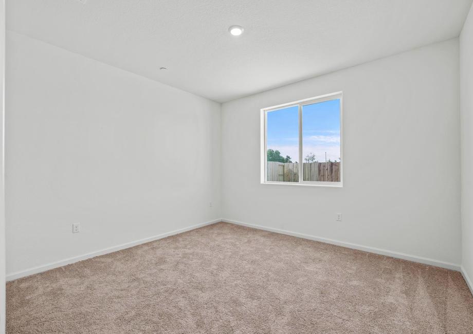 The master bedroom has a large window and is spacious. 